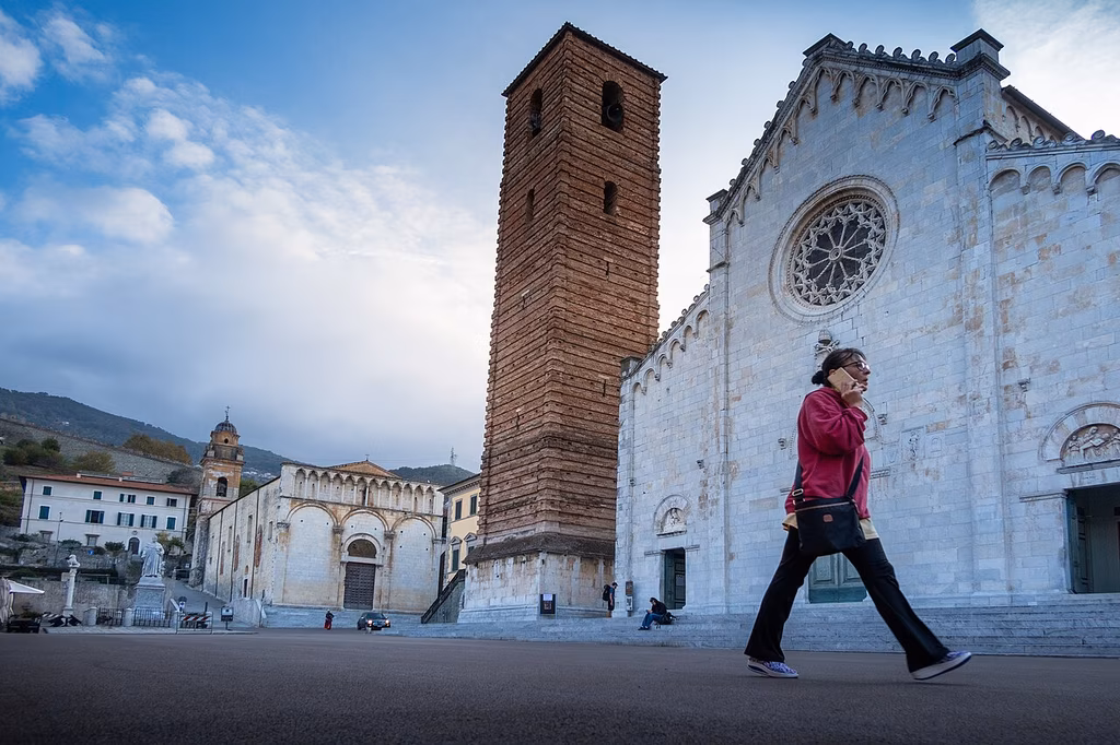 The marble Duomo and brick bell tower on Piazza Duomo in Pietrasanta